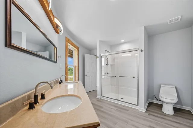 a bathroom with a sink toilet and shower