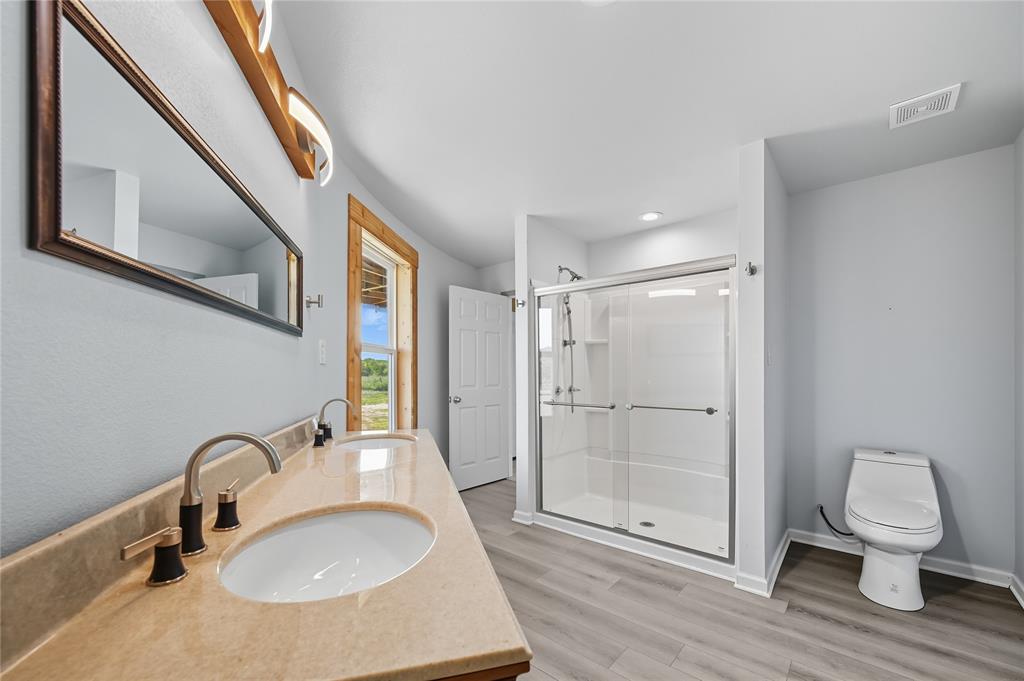 9833 Private Rd. 5377 Nevada, TX 75173 - Photo 14 of 40 a bathroom with a sink toilet and shower