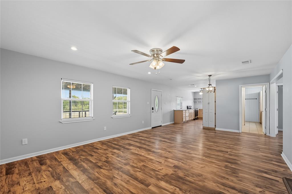 9833 Private Rd. 5377 Nevada, TX 75173 - Photo 25 of 40 a view of empty room with wooden floor and fan