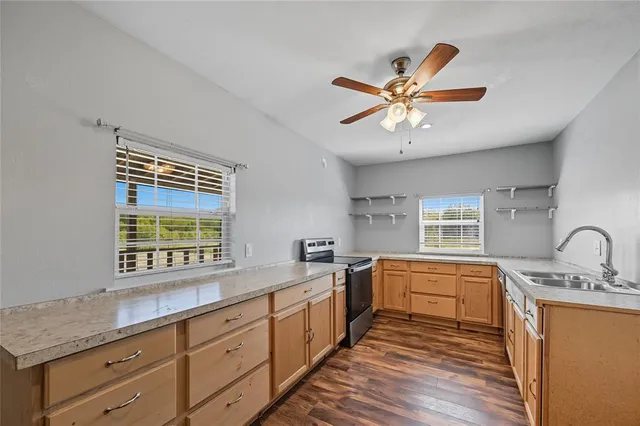 a kitchen with a sink window and cabinets
