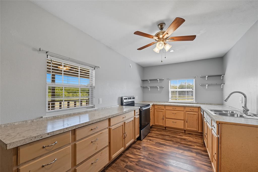 9833 Private Rd. 5377 Nevada, TX 75173 - Photo 26 of 40 a kitchen with a sink window and cabinets
