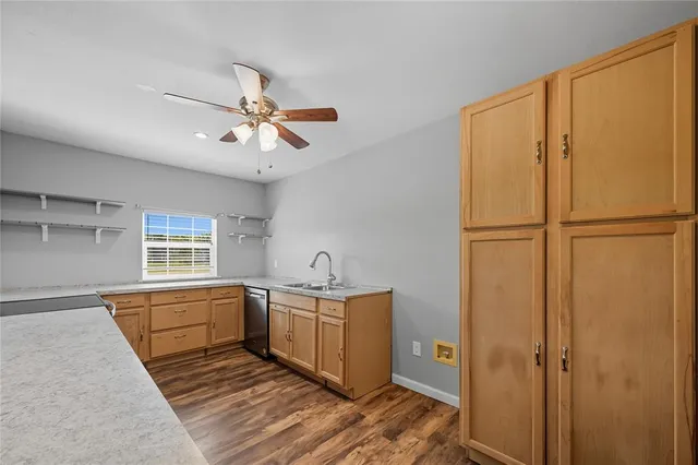 a kitchen with a refrigerator a sink and cabinets