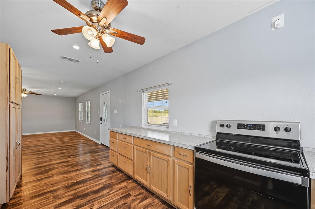 9833 Private Rd. 5377 Nevada, TX 75173 - Photo 28 of 40 a kitchen with a stove and a microwave