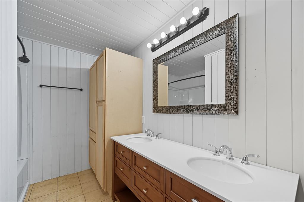 9833 Private Rd. 5377 Nevada, TX 75173 - Photo 30 of 40 a bathroom with a double vanity sink and a mirror