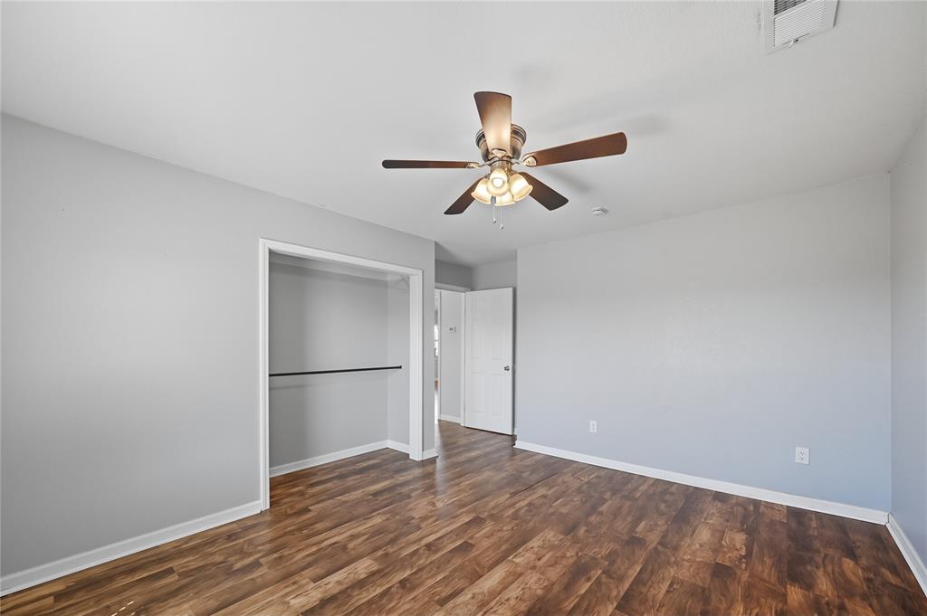 9833 Private Rd. 5377 Nevada, TX 75173 - Photo 32 of 40 a view of a room with wooden floor and a ceiling fan
