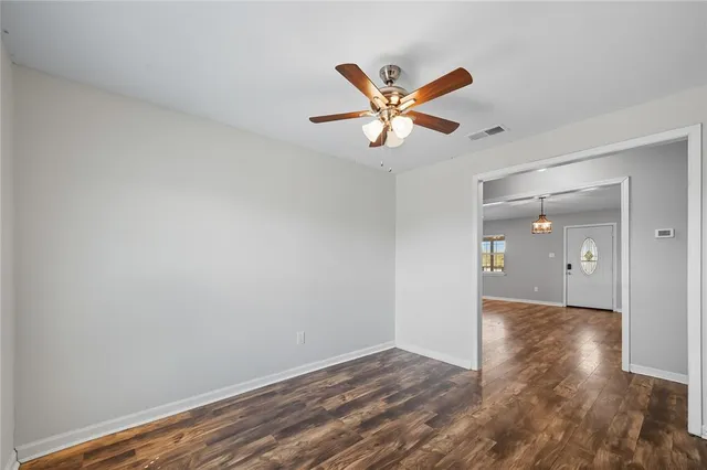 a view of an empty room and wooden floor