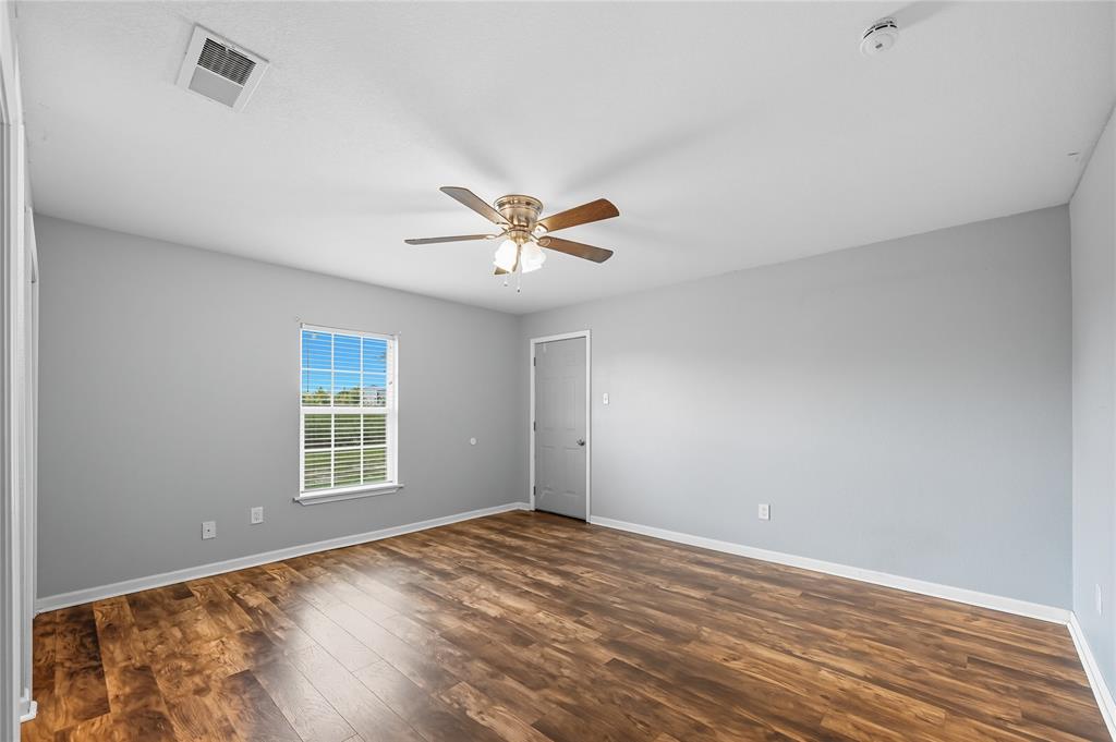 9833 Private Rd. 5377 Nevada, TX 75173 - Photo 37 of 40 wooden floor in an empty room with a window