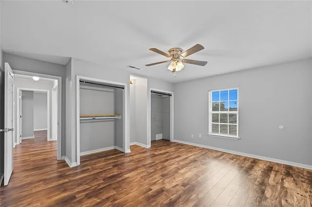 a view of a livingroom with wooden floor and a window