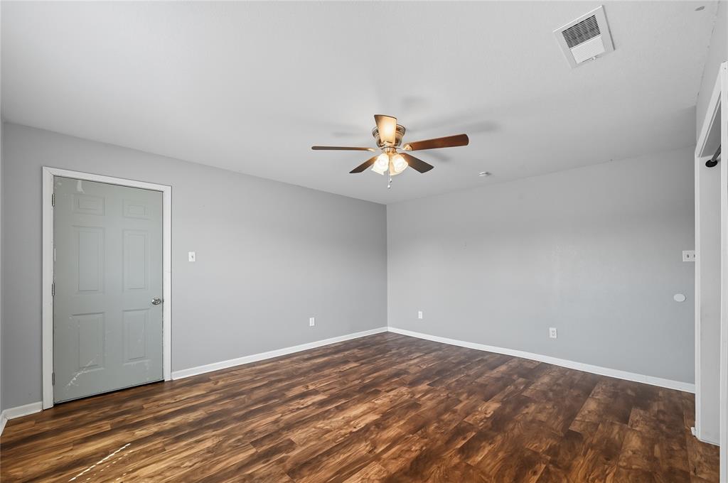 9833 Private Rd. 5377 Nevada, TX 75173 - Photo 39 of 40 a view of empty room with wooden floor and fan