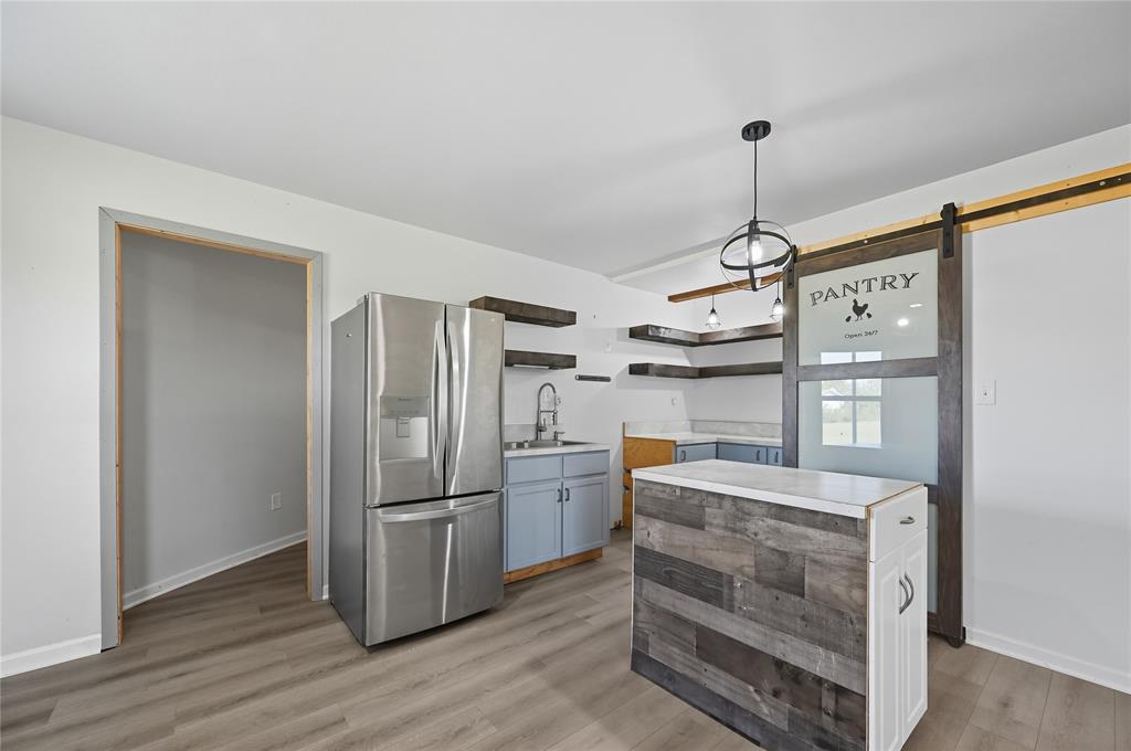 9833 Private Rd. 5377 Nevada, TX 75173 - Photo 10 of 40 a kitchen with stainless steel appliances granite countertop a refrigerator and a sink
