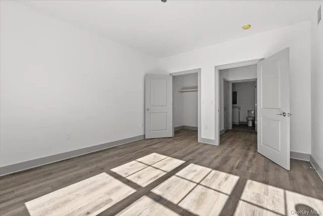 a view of an empty room and wooden floor