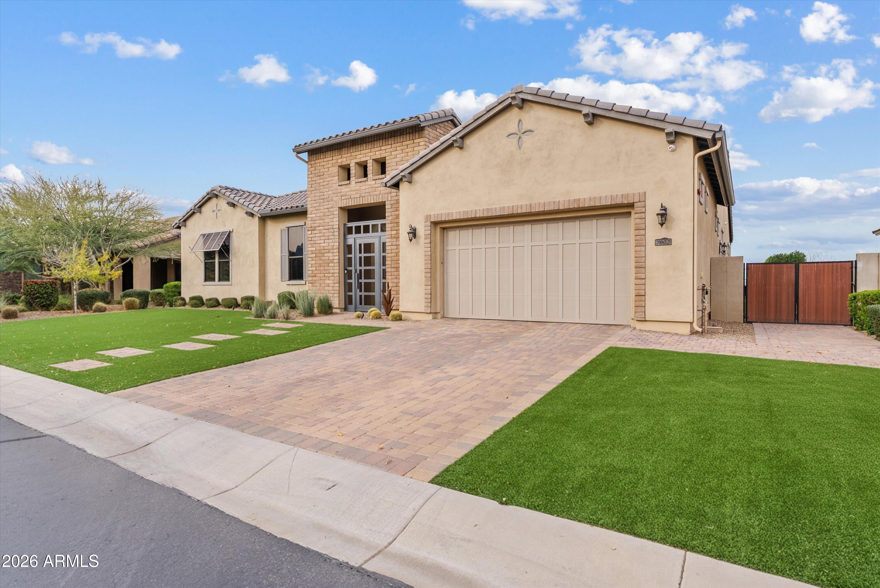 7002 South Portland Avenue Gilbert, AZ 85298 - Photo 13 of 40 a front view of a house with a yard and garage