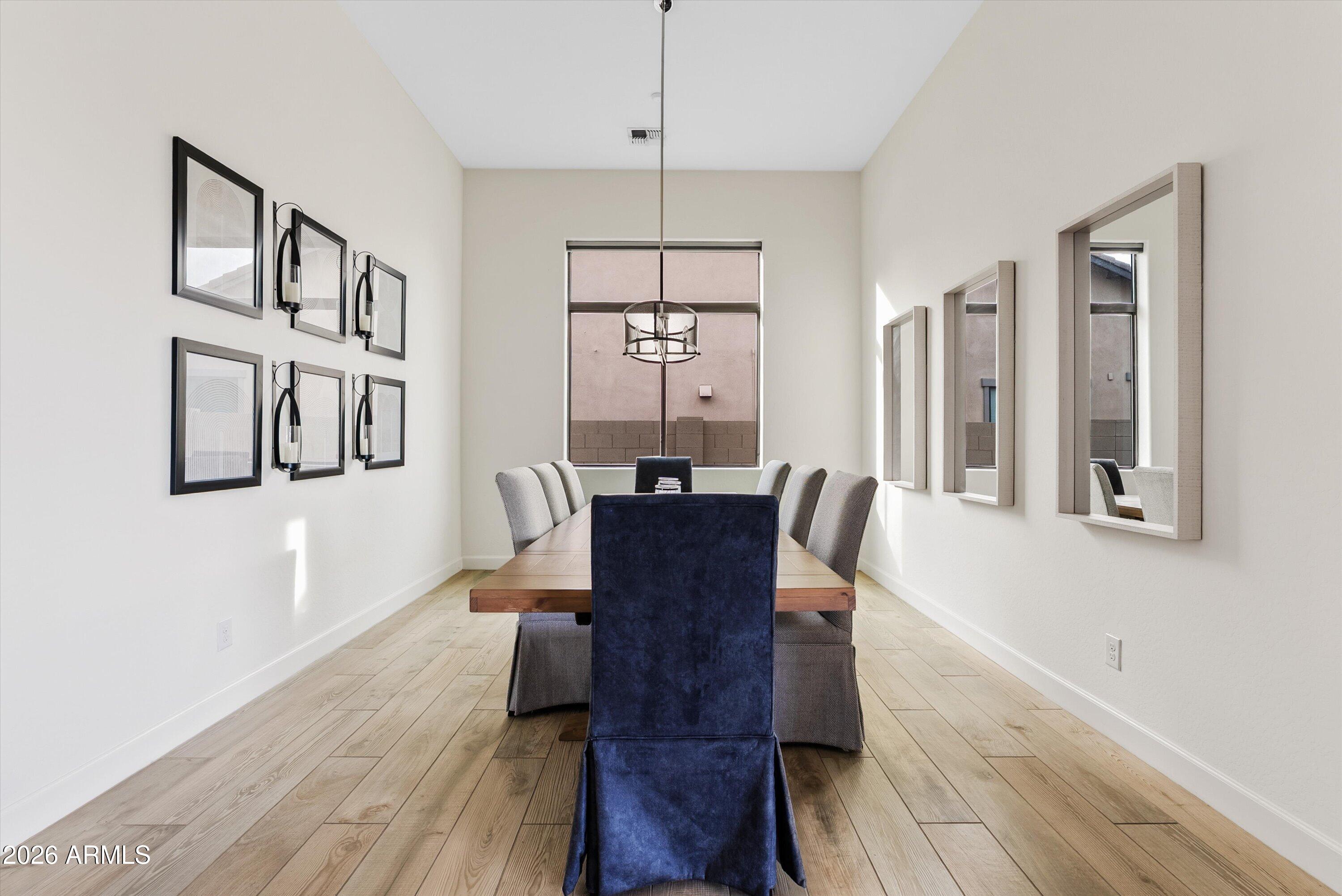 7002 South Portland Avenue Gilbert, AZ 85298 - Photo 20 of 40 a view of a dining room with furniture window and wooden floor