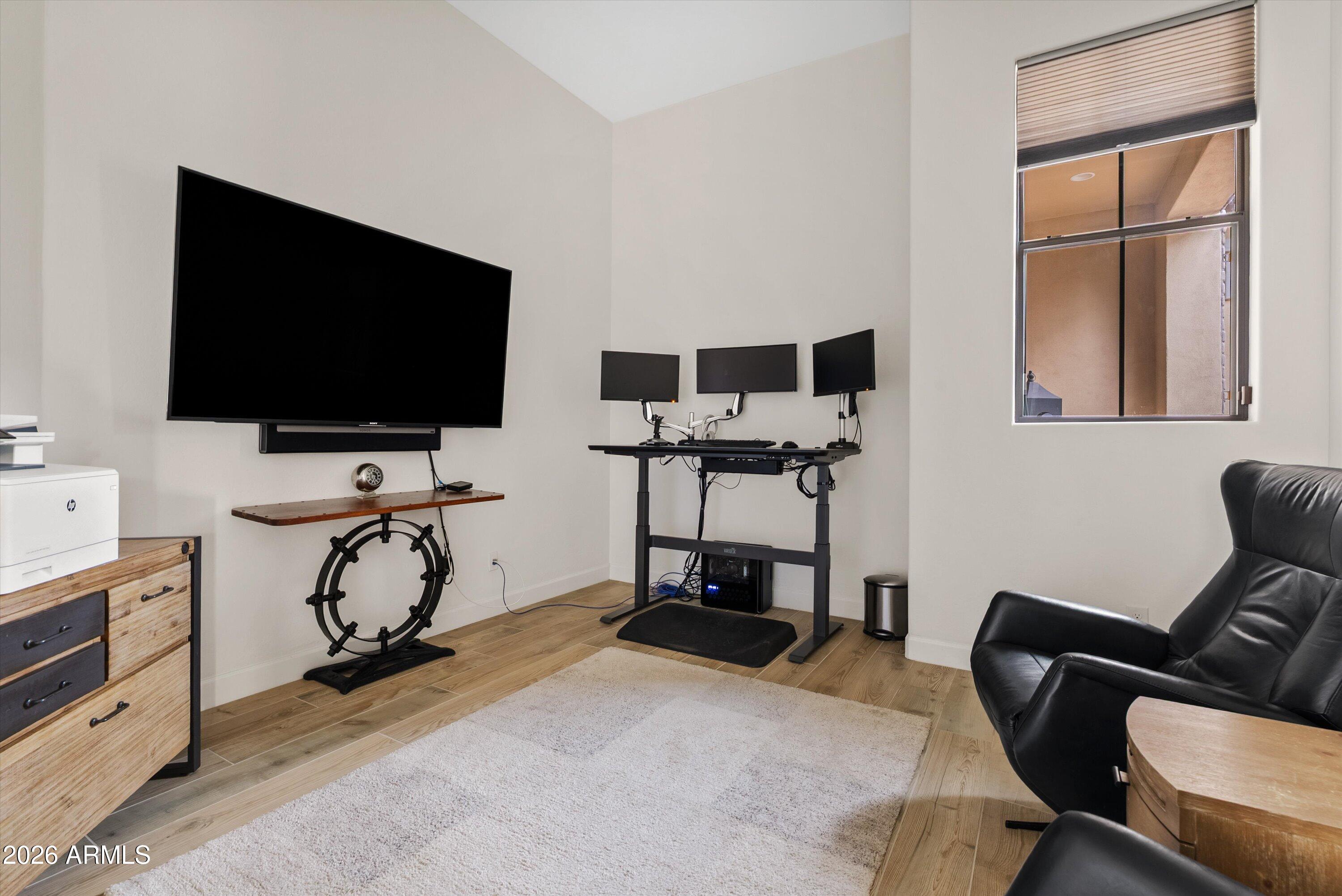 7002 South Portland Avenue Gilbert, AZ 85298 - Photo 21 of 40 a view of a workspace with furniture and a flat screen tv