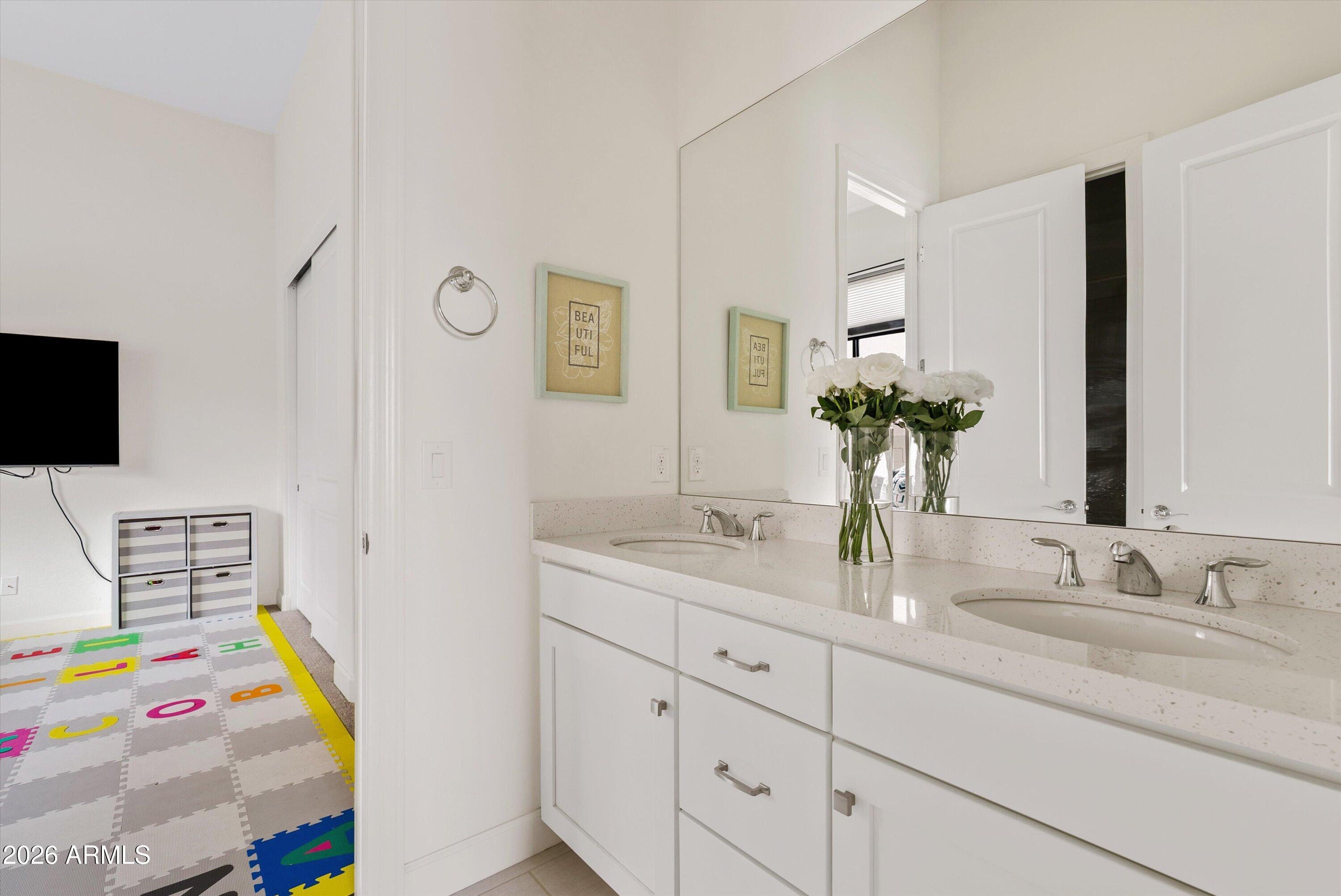 7002 South Portland Avenue Gilbert, AZ 85298 - Photo 23 of 40 a bathroom with a sink double vanity and tub