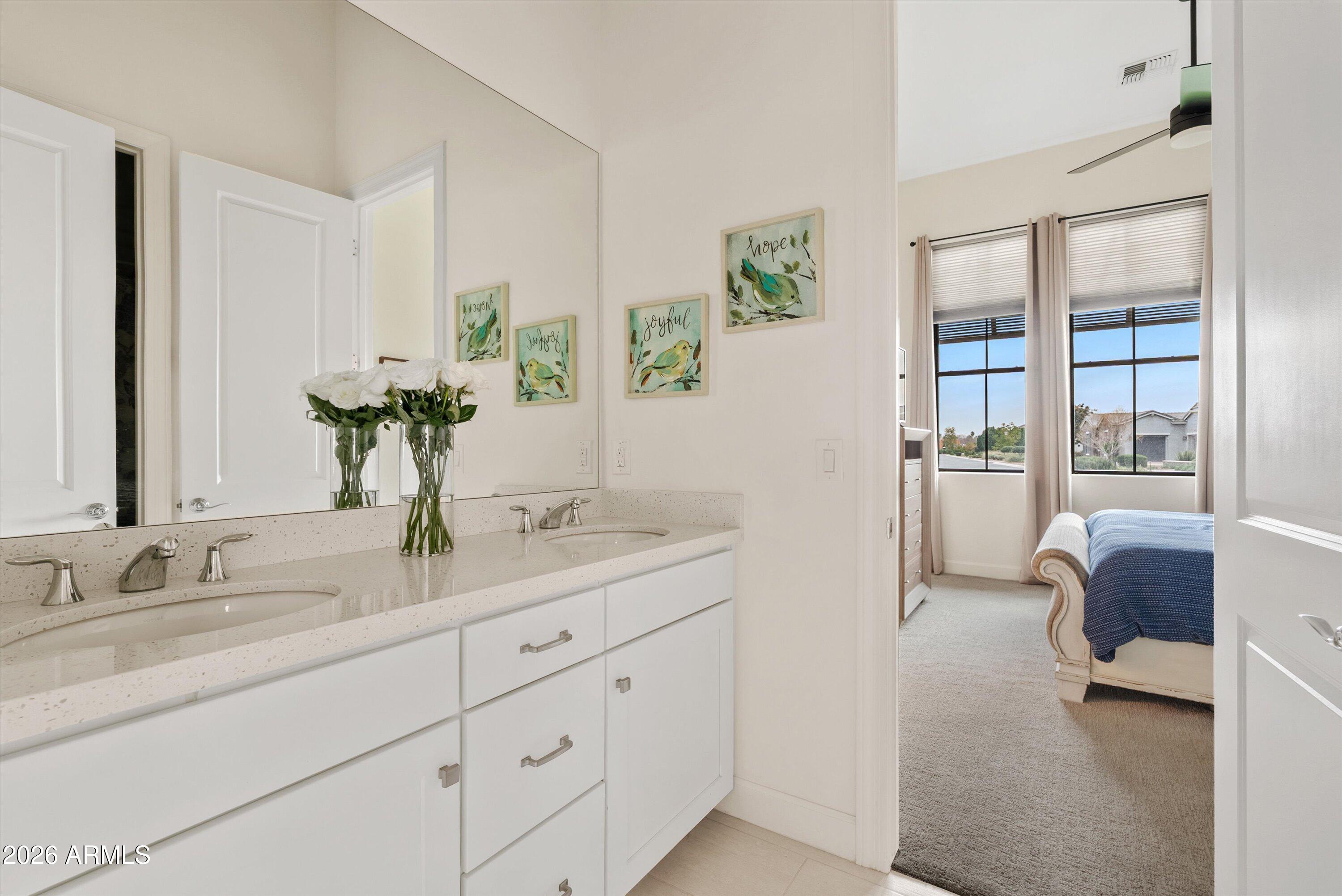 7002 South Portland Avenue Gilbert, AZ 85298 - Photo 25 of 40 a en suite bathroom with a granite countertop sink and a mirror
