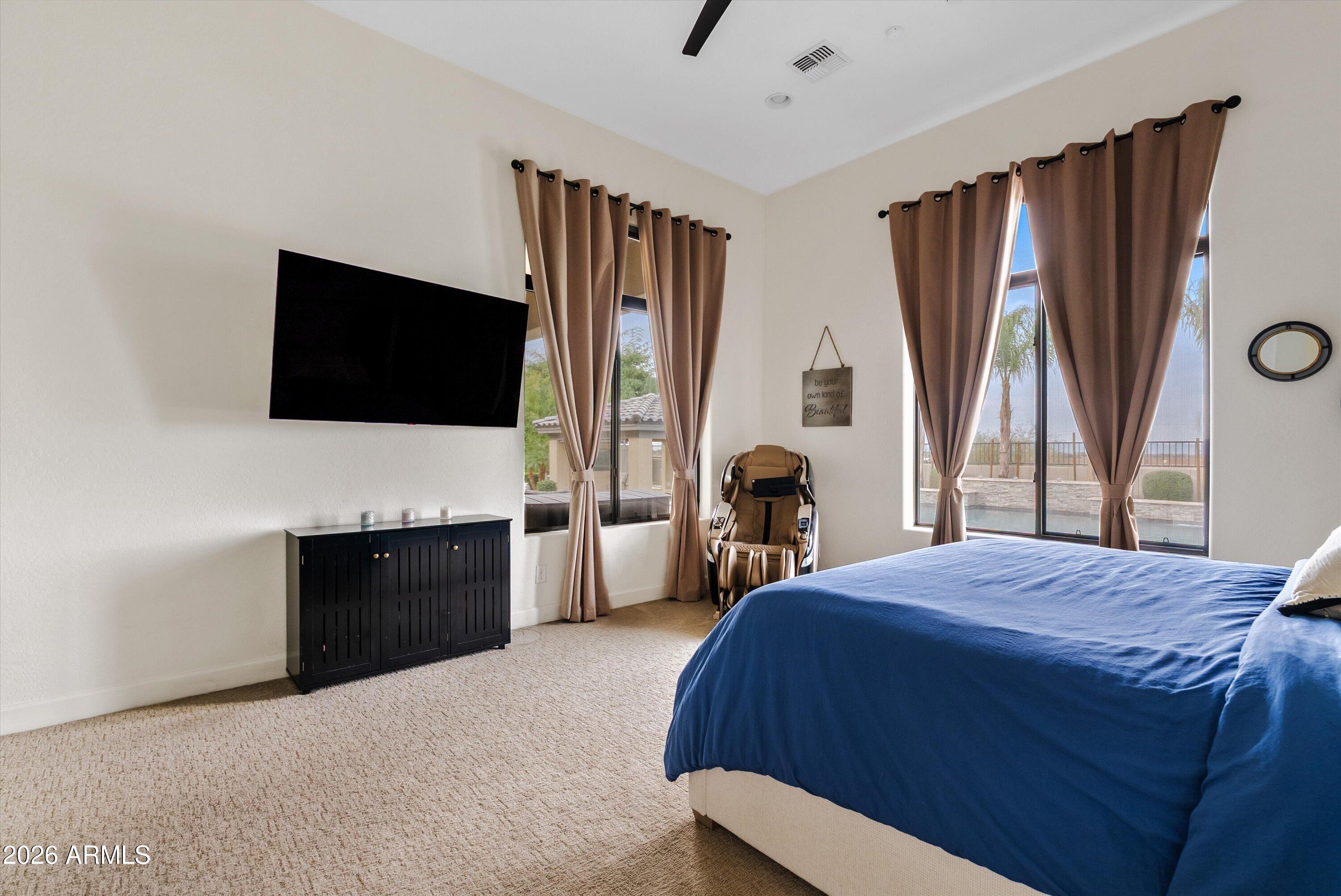 7002 South Portland Avenue Gilbert, AZ 85298 - Photo 29 of 40 a bedroom with a bed television window and a flat screen television