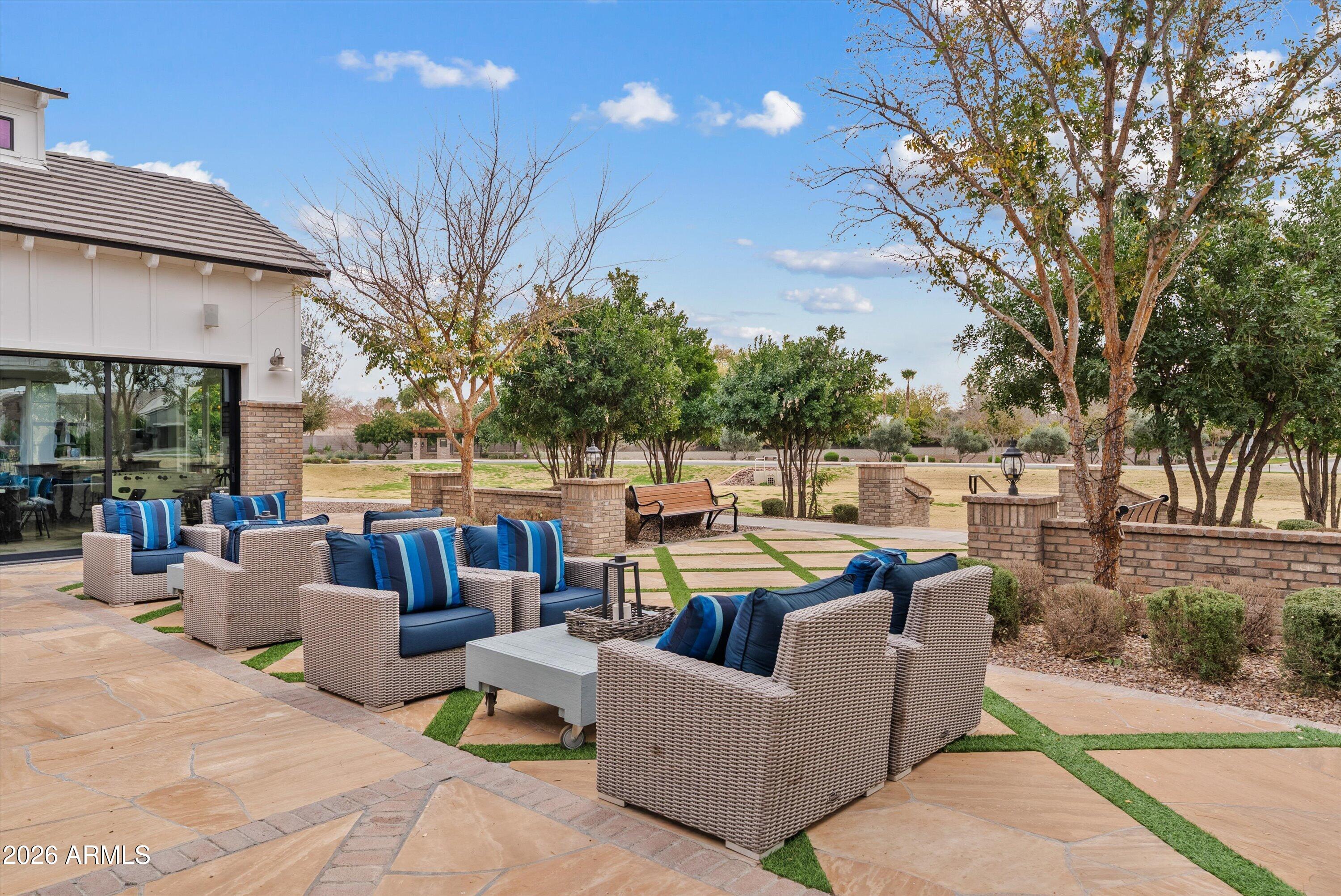 7002 South Portland Avenue Gilbert, AZ 85298 - Photo 3 of 40 a view of a patio with couches and a fire pit