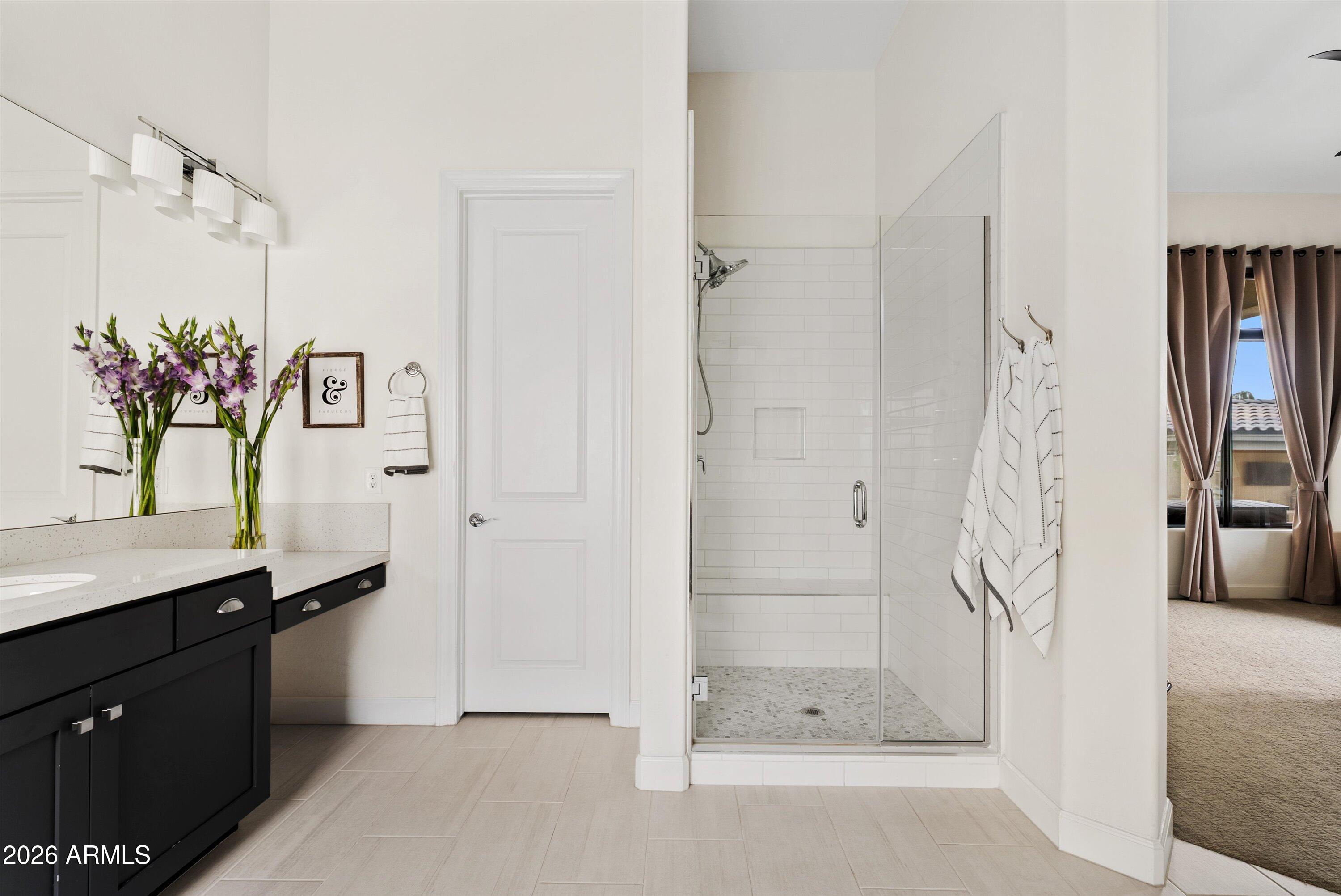 7002 South Portland Avenue Gilbert, AZ 85298 - Photo 31 of 40 a bathroom with a shower sink and mirror