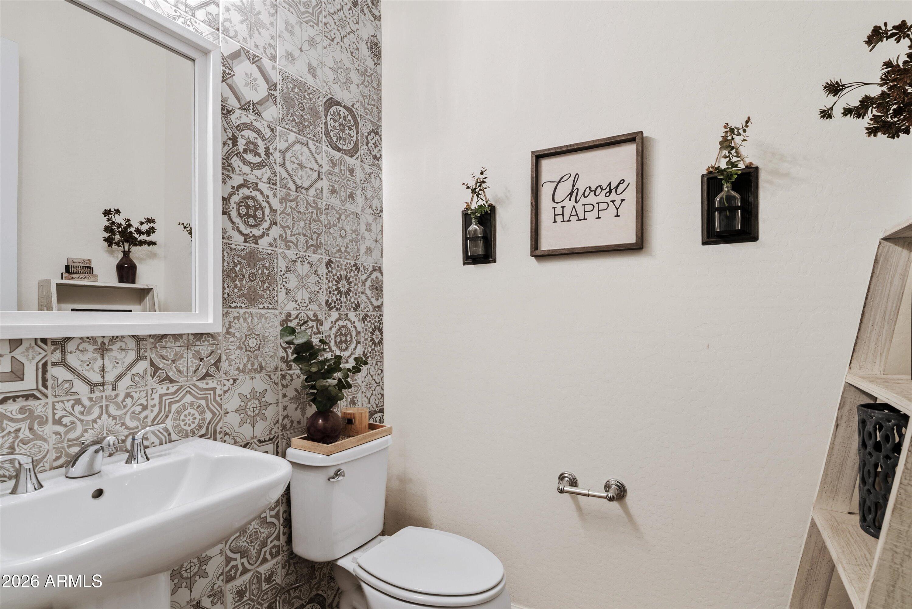 7002 South Portland Avenue Gilbert, AZ 85298 - Photo 32 of 40 a bathroom with a sink and mirror with toilet