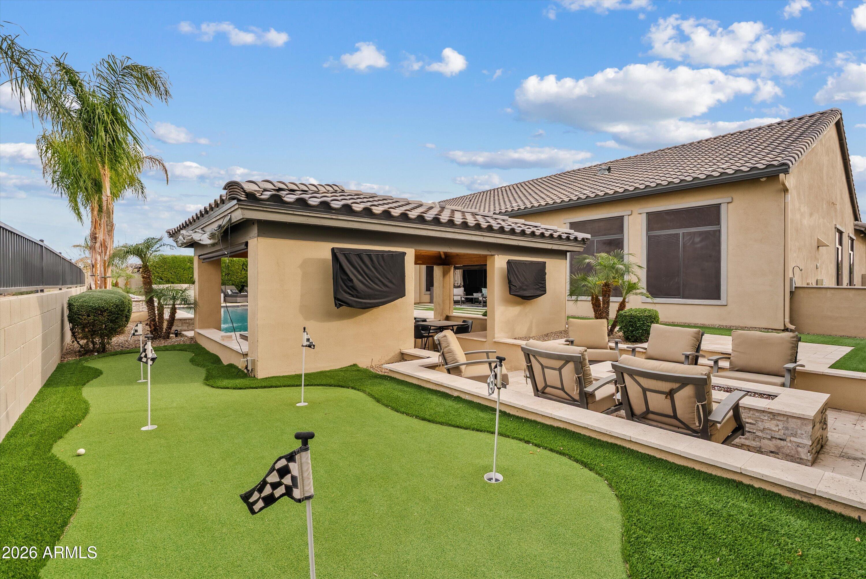7002 South Portland Avenue Gilbert, AZ 85298 - Photo 38 of 40 a view of a house with backyard sitting area and garden
