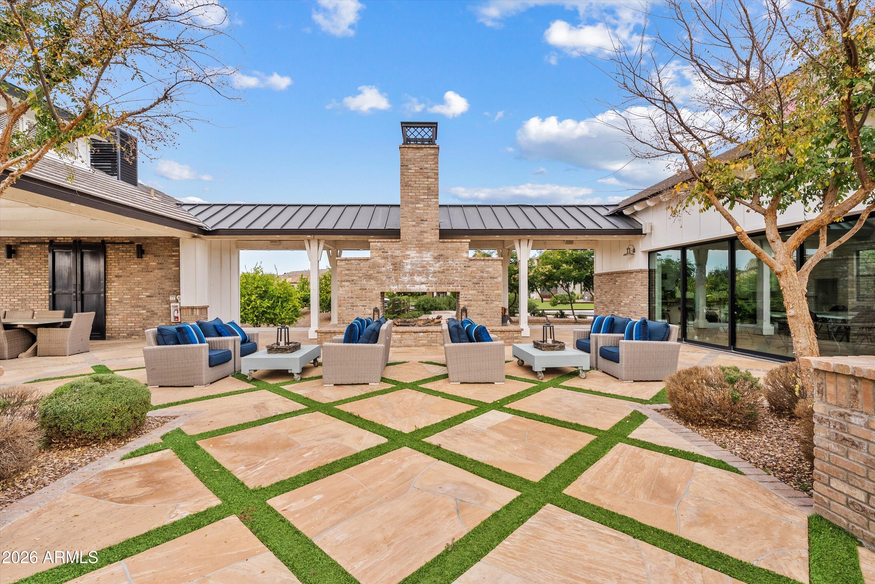 7002 South Portland Avenue Gilbert, AZ 85298 - Photo 5 of 40 a living room with patio furniture and a large tree