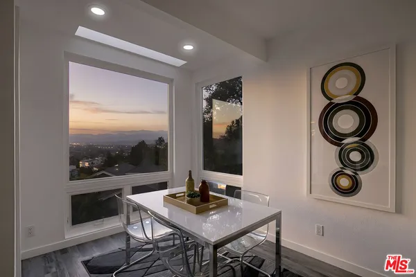 a view of a workspace with furniture and wooden floor