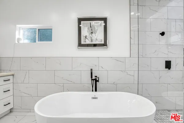 a white bath tub sitting in a bathroom