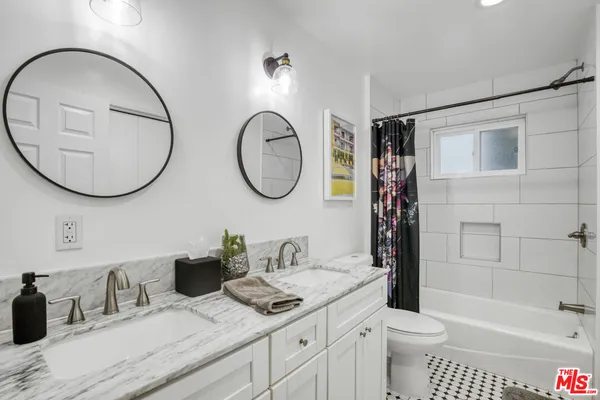 a bathroom with a toilet a sink and a mirror