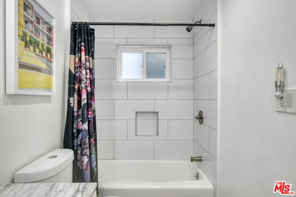 a bathroom with a toilet and shower