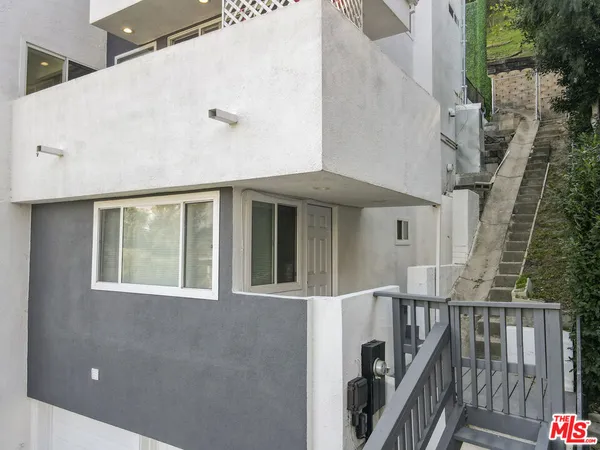 a front view of a house with iron stairs