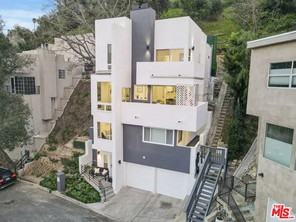 an aerial view of residential houses with outdoor space