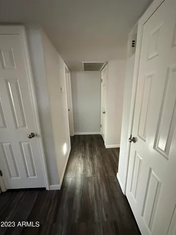 a view of a hallway with wooden floor