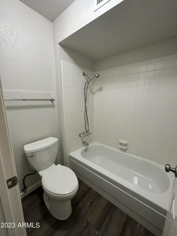 a bathroom with a toilet a sink and bathtub