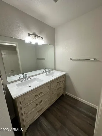 a bathroom with a double vanity sink and mirror