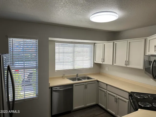 a kitchen with granite countertop a sink and a window