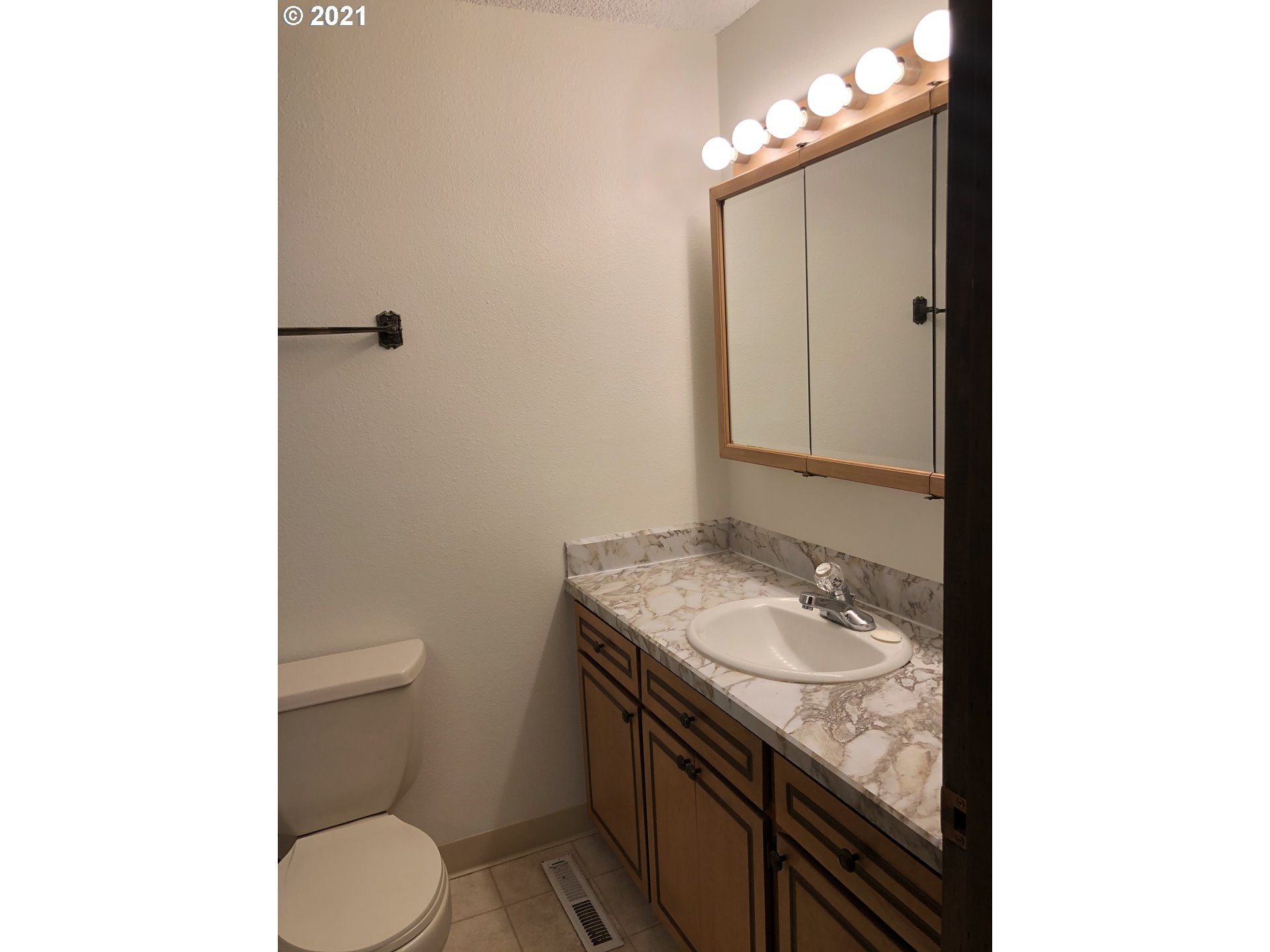 4520 Southwest Olson Avenue Pendleton, OR 97801 - Photo 15 of 22 a bathroom with a granite countertop sink a toilet and a mirror