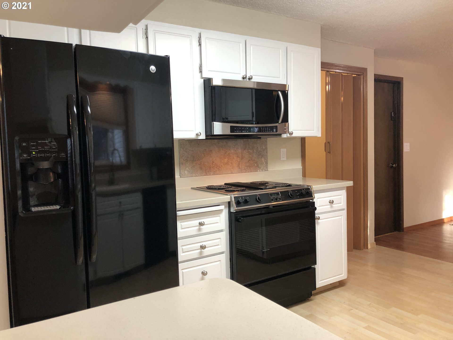 4520 Southwest Olson Avenue Pendleton, OR 97801 - Photo 5 of 22 a kitchen with stainless steel appliances kitchen island a refrigerator and a stove top oven