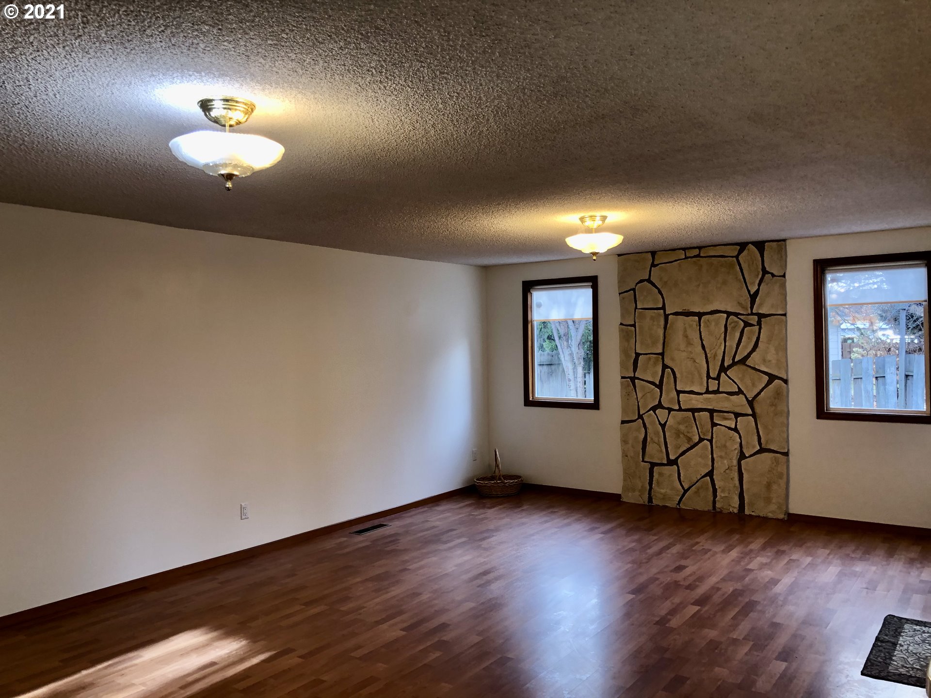 4520 Southwest Olson Avenue Pendleton, OR 97801 - Photo 6 of 22 an empty room with wooden floor and windows