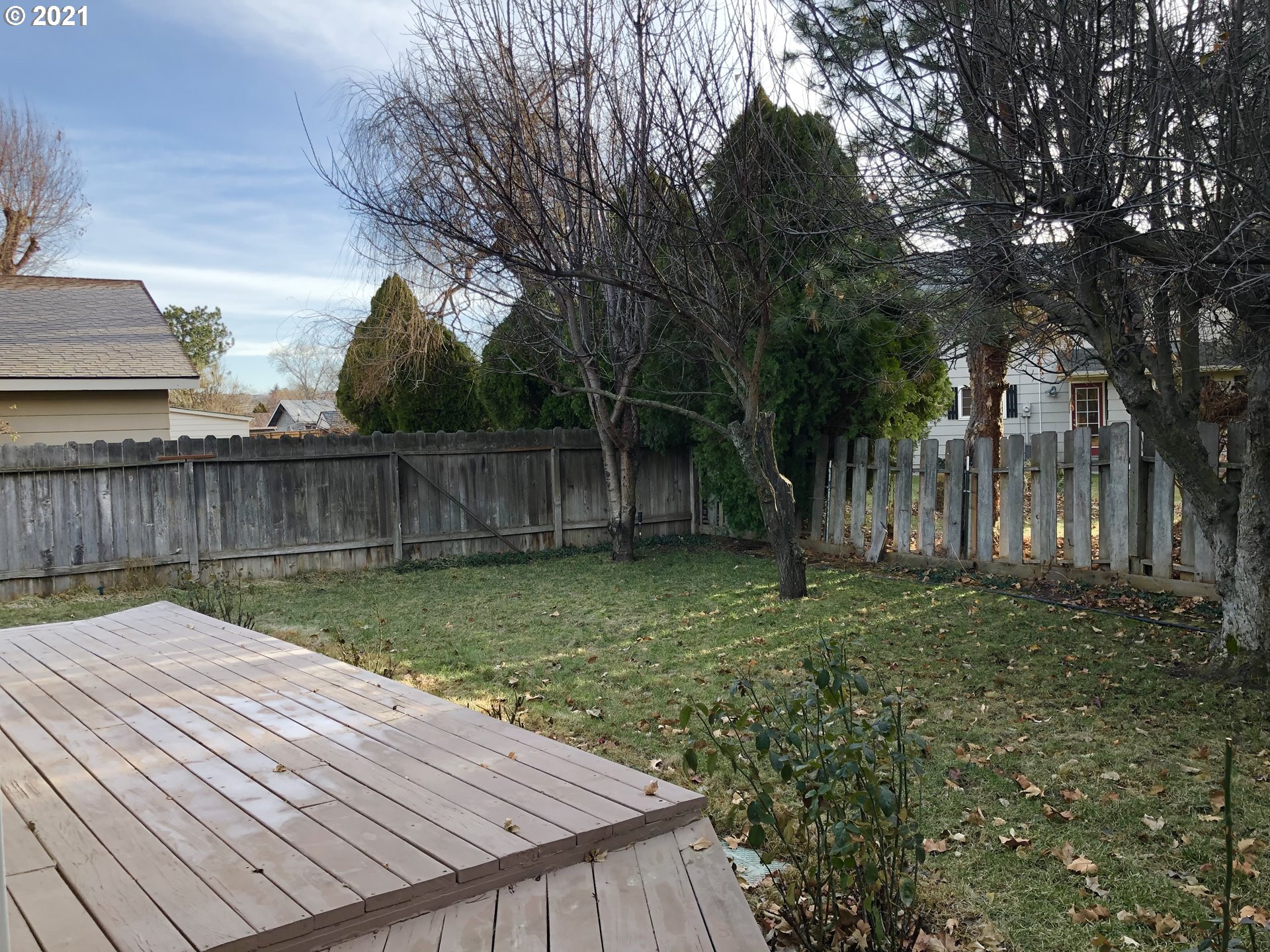 4520 Southwest Olson Avenue Pendleton, OR 97801 - Photo 9 of 22 a view of backyard with wooden fence and large trees