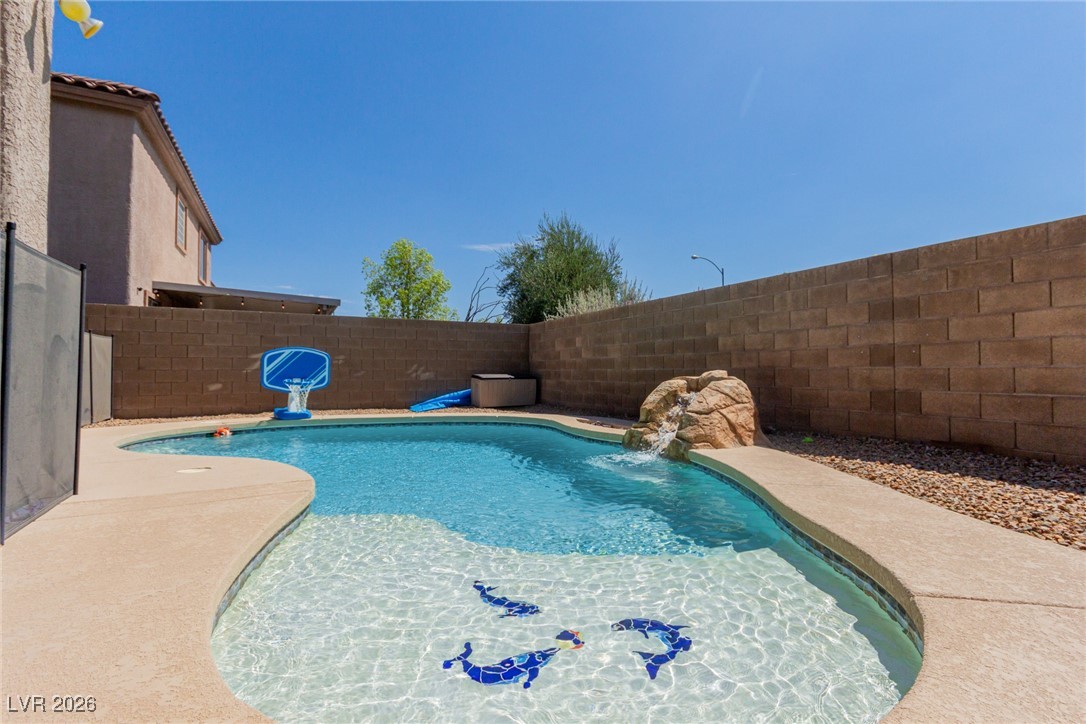 113 Lovage Street Henderson, NV 89002 - Photo 1 of 27 View of pool featuring a fenced backyard and a patio area