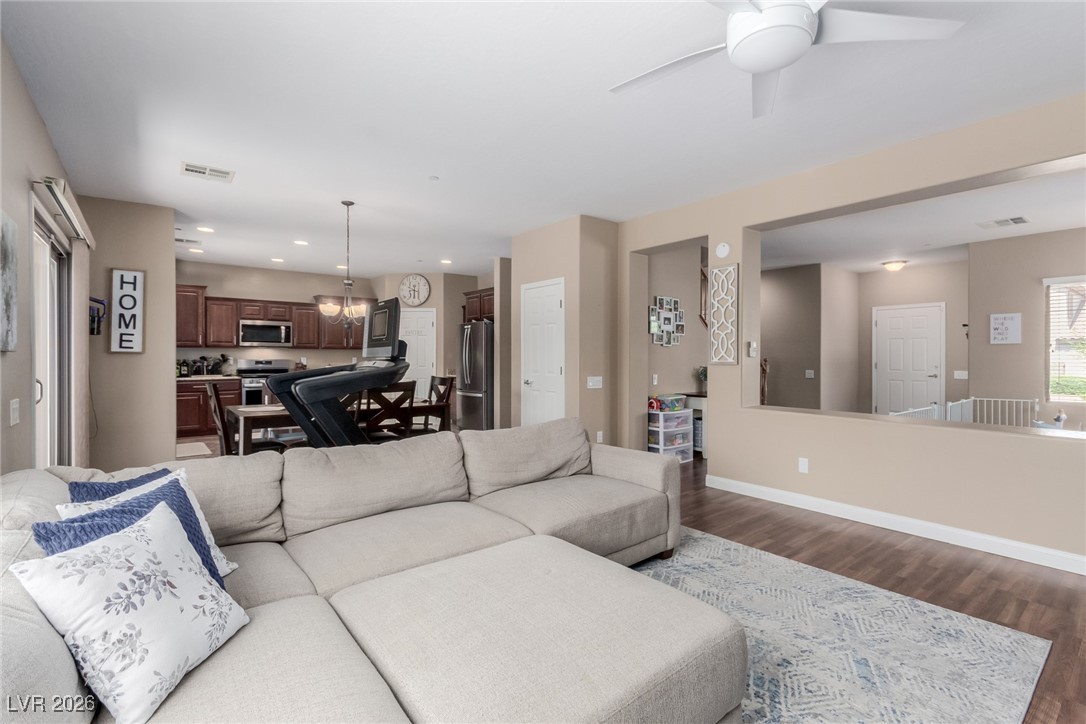113 Lovage Street Henderson, NV 89002 - Photo 11 of 27 Living area with wood finished floors, a chandelier, ceiling fan, and recessed lighting