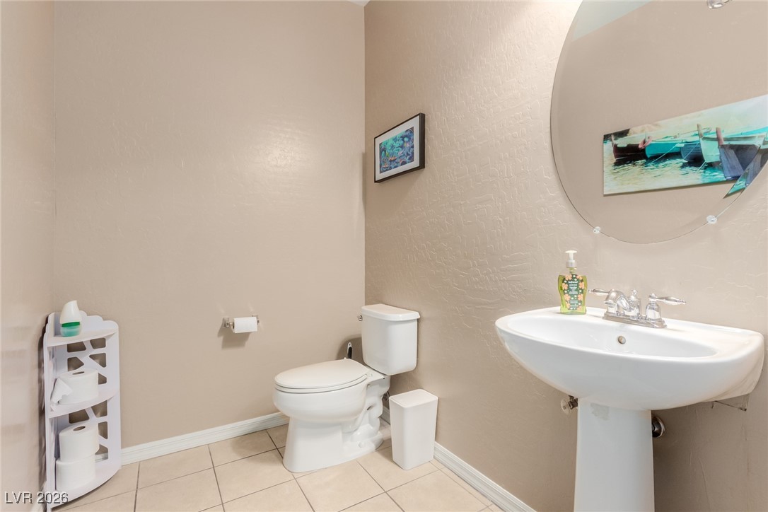 113 Lovage Street Henderson, NV 89002 - Photo 14 of 27 Half bathroom featuring light tile patterned floors and a textured wall