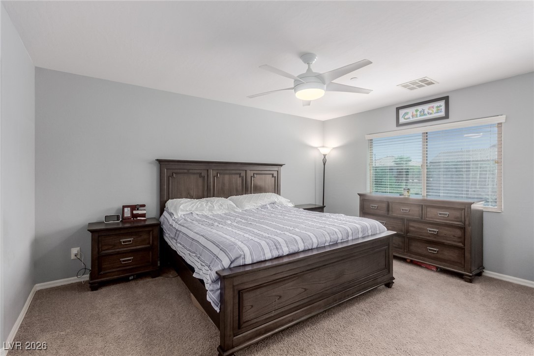 113 Lovage Street Henderson, NV 89002 - Photo 15 of 27 Bedroom with light carpet and a ceiling fan