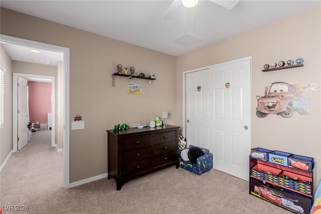 113 Lovage Street Henderson, NV 89002 - Photo 22 of 27 Bedroom featuring light carpet and a ceiling fan