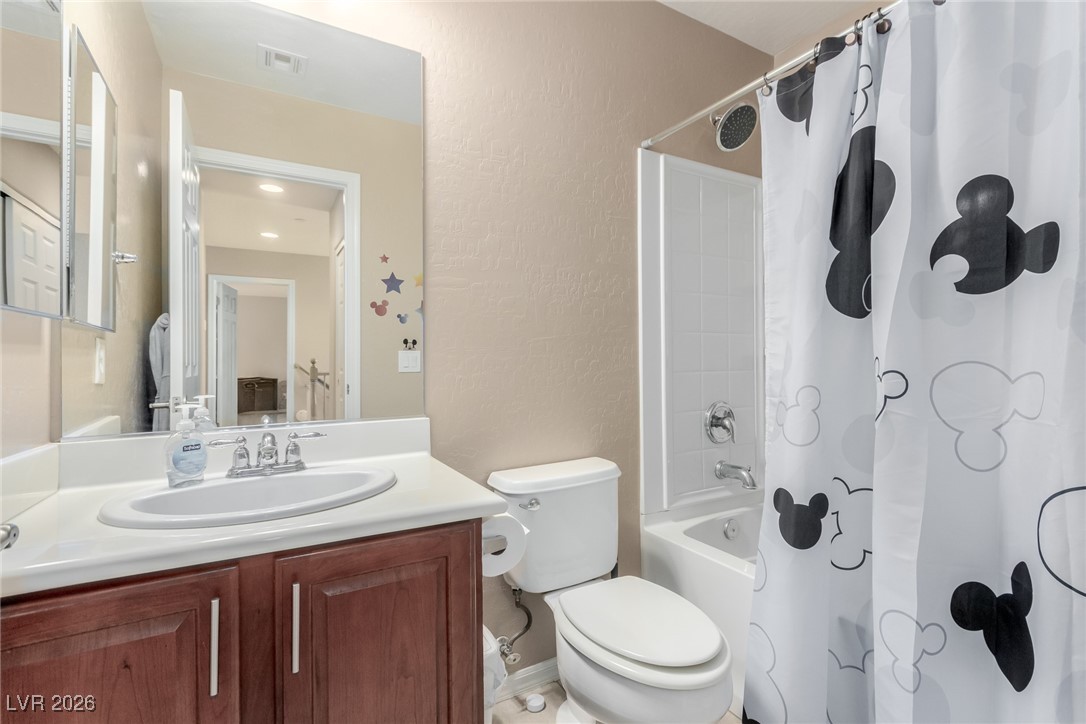 113 Lovage Street Henderson, NV 89002 - Photo 23 of 27 Bathroom featuring shower / tub combo, vanity, and a textured wall