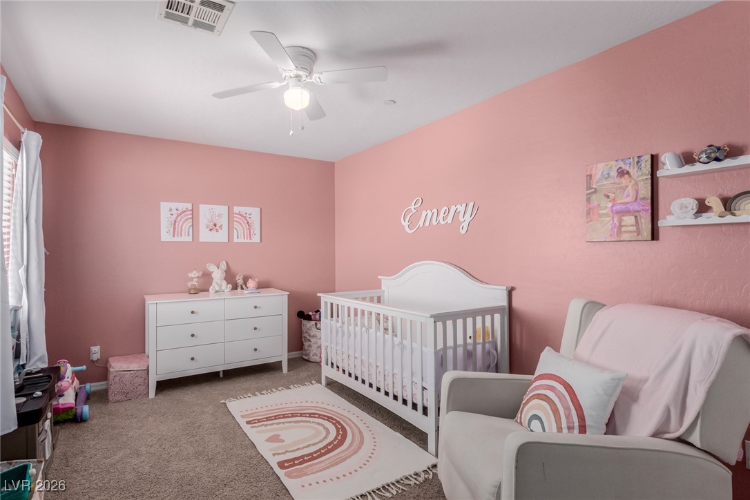113 Lovage Street Henderson, NV 89002 - Photo 24 of 27 Bedroom with carpet flooring, a crib, and ceiling fan