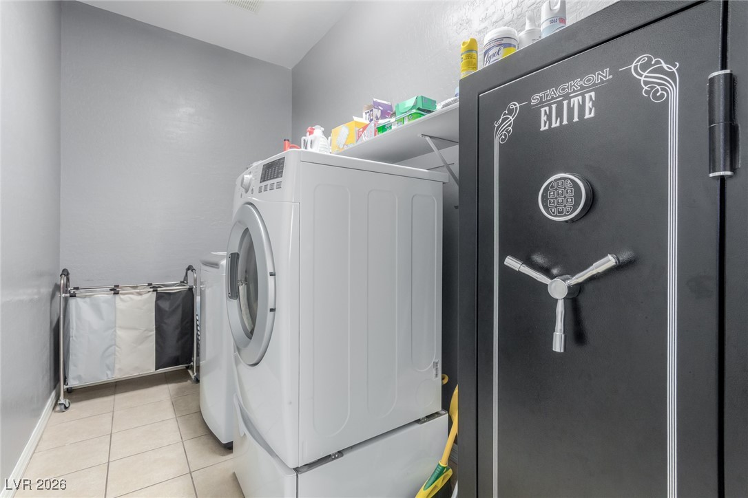113 Lovage Street Henderson, NV 89002 - Photo 26 of 27 Laundry room featuring light tile patterned flooring and washing machine and dryer