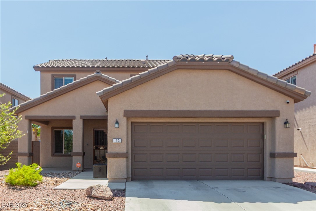 113 Lovage Street Henderson, NV 89002 - Photo 3 of 27 Mediterranean / spanish-style house featuring stucco siding, an attached garage, and driveway