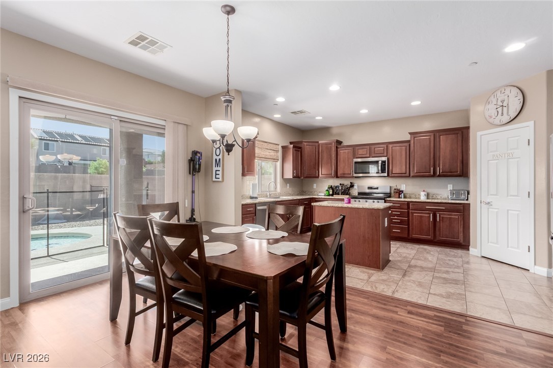 113 Lovage Street Henderson, NV 89002 - Photo 4 of 27 Dining room featuring recessed lighting, light wood-style floors, and a chandelier
